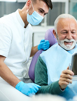 An older man happy with his new dental bridge
