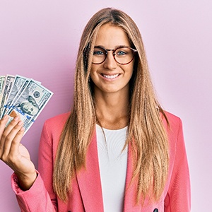 woman smiling and holding money