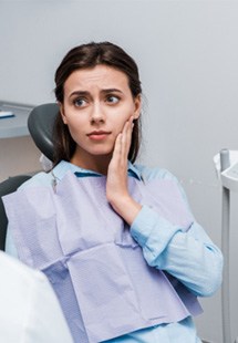 Woman looking concerned while talking to dentist 