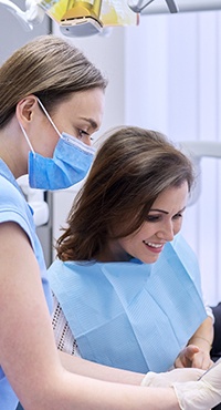 patient and dental assistant looking at a tablet 