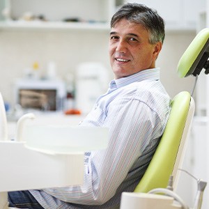 Man smiling while sitting in treatment chair