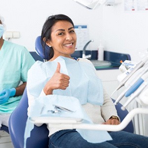 A smiling woman pleased with her new dental bridge