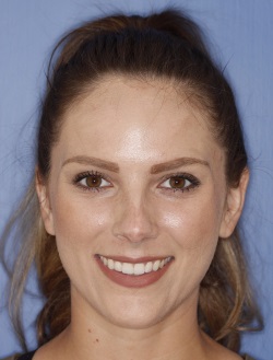 Smiling brunette woman with hair up