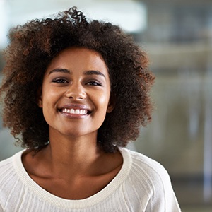 smiling woman in a white sweater