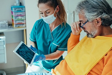 Dentist and patient reviewing oral X-ray