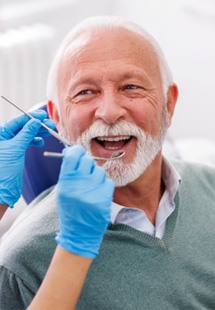 Mature man smiling during dental checkup 