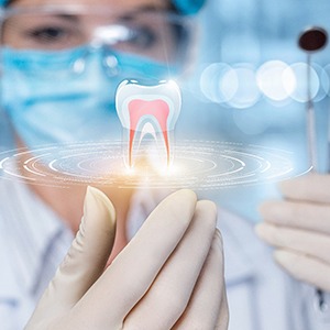 dentist holding instruments and a hologram of a tooth