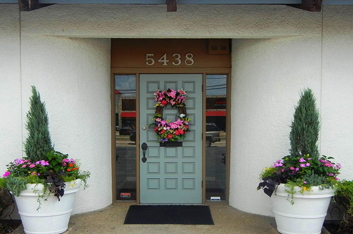 Flower wreath on front door of North Dallas dental office
