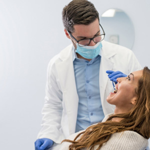 A dentist checking his patient’s smile