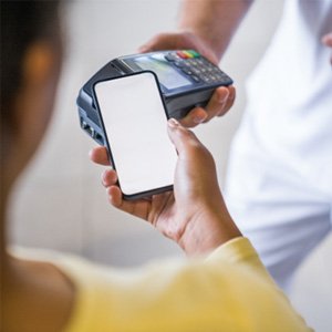 A cropped image of a patient using their phone to pay the cost of veneers