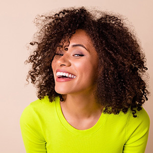 Smiling woman in bright yellow blouse