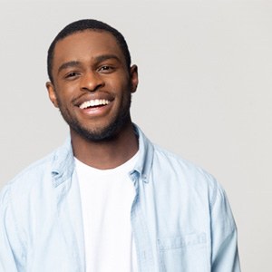 Man in blue button-up shirt smiling