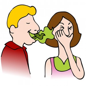 An image of a man with bad breath talking to a woman.