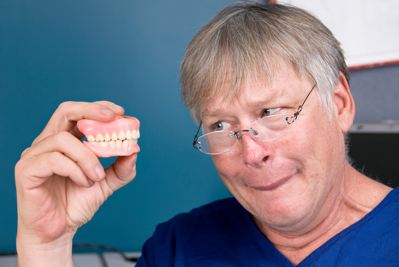 Patient looking skeptically at their dentures